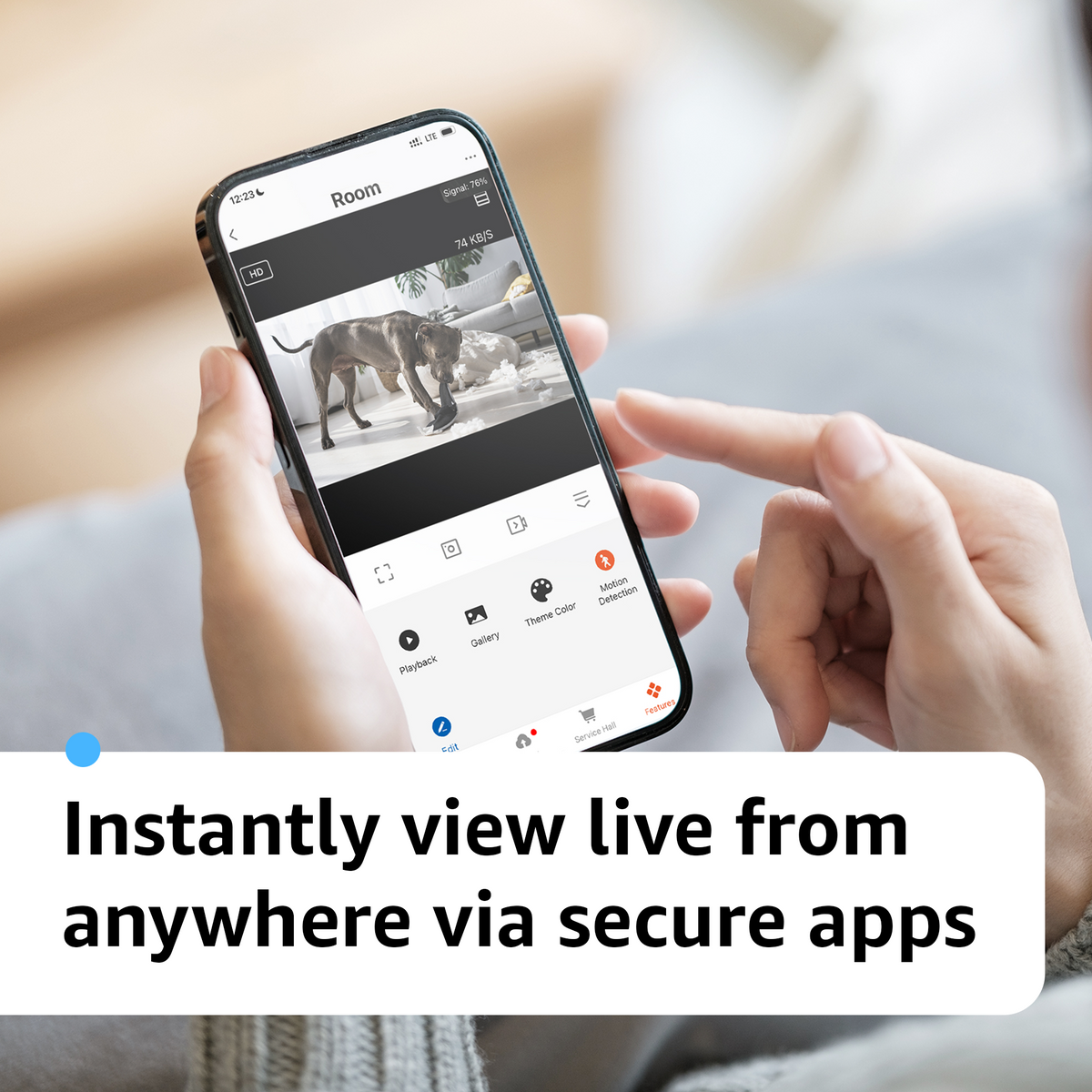 Phone showing a live view of a dog in the camera app, with playback and motion detection controls.
